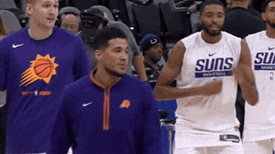 A Group Of Basketball Players With One Wearing A Shirt That Says Suns GIF