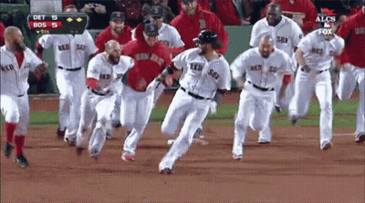 A Group Of Boston Red Sox Players Are Running On The Field GIF