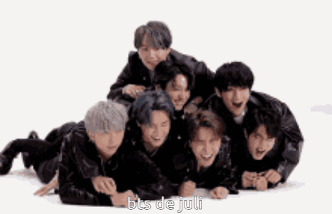 A Group Of Boys Are Laying On The Floor With The Words Bts De Juli Written On The Bottom . GIF