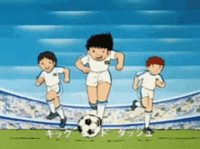 A Group Of Boys Are Playing Soccer On A Field With A Soccer Ball . GIF