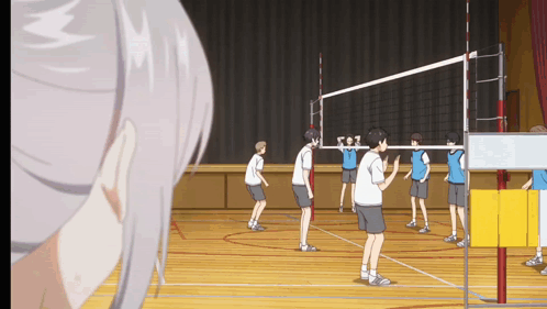 A Group Of Boys Are Playing Volleyball In A Gym GIF