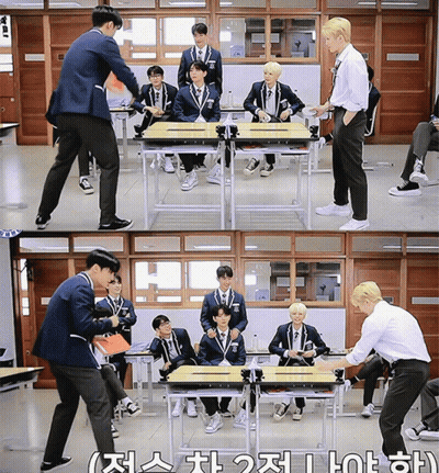 A Group Of Boys Are Sitting At Desks In A Classroom With Korean Writing On The Bottom Left GIF