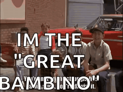 A Group Of Boys Are Sitting In Front Of A Red Car With The Words " Im The Great Bambino " GIF