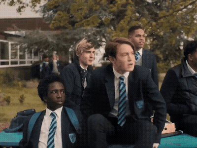 A Group Of Boys Are Sitting On A Bench And One Of Them Has The Letter F On His Uniform GIF
