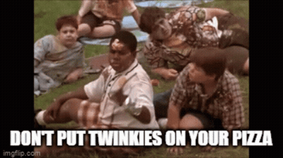 A Group Of Boys Are Sitting On The Grass Eating Pizza And A Man Is Holding A Pizza In His Hand . GIF