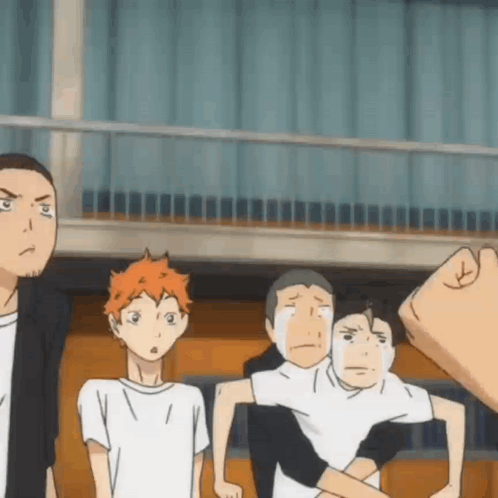 A Group Of Boys Are Standing Next To Each Other In A Room . GIF