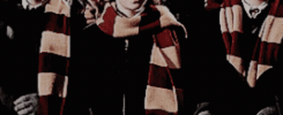 A Group Of Boys Wearing Scarves Are Standing Next To Each Other . GIF