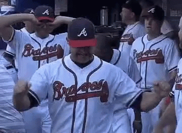 A Group Of Braves Baseball Players Are Standing Next To Each Other In A Dugout . GIF