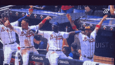 A Group Of Braves Baseball Players Celebrate Their Victory GIF
