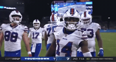 A Group Of Buffalo Bills Football Players Are Standing On The Field GIF