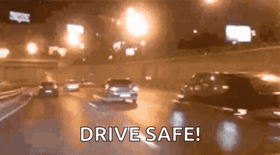 A Group Of Cars Are Driving Down A Highway At Night And The Words `` Drive Safe '' Are Visible . GIF