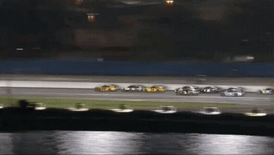 A Group Of Cars Are Racing On A Race Track GIF