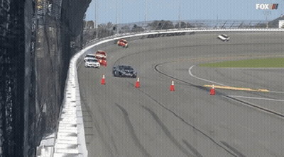 A Group Of Cars Are Racing On A Race Track With A Fox Logo In The Background GIF