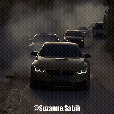 A Group Of Cars Driving Down A Road With Smoke Coming Out Of Their Tires GIF