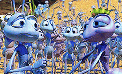 A Group Of Cartoon Ants Are Standing In The Sand GIF