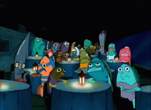 A Group Of Cartoon Characters Are Sitting Around A Table With A Lantern . GIF