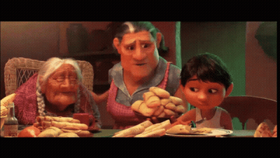 A Group Of Cartoon Characters Are Sitting At A Table With Food GIF