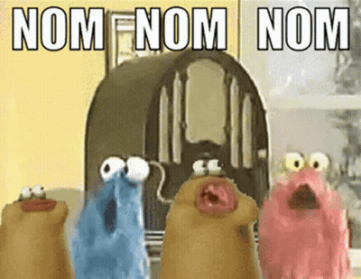 A Group Of Cartoon Characters Are Standing In Front Of A Radio With The Words Nom Nom Nom Written On It GIF