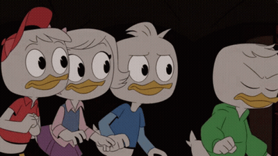 A Group Of Cartoon Ducks Are Standing Next To Each Other In A Dark Room GIF