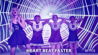 A Group Of Cheerleaders Are Dancing In Front Of A Spider Web And The Words Heart Beat Faster Are On The Screen GIF