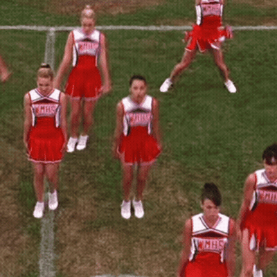 A Group Of Cheerleaders Are Performing A Dance On A Field . GIF