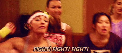 A Group Of Cheerleaders Are Standing In A Room And One Of Them Is Saying Fight ! Fight ! Fight ! GIF