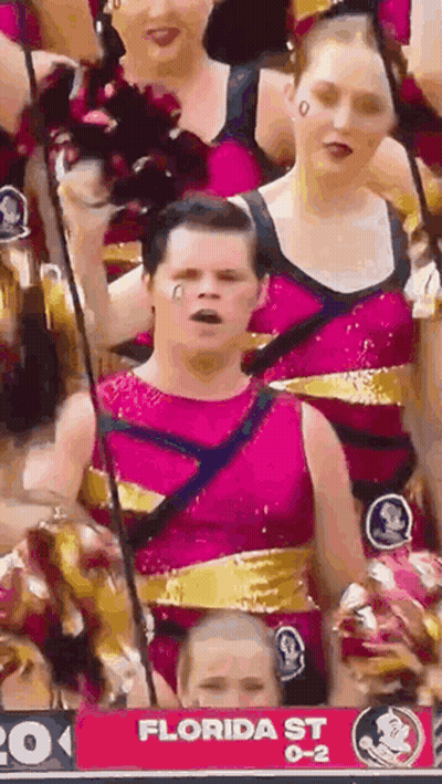 A Group Of Cheerleaders Are Standing In Front Of A Florida St Sign . GIF