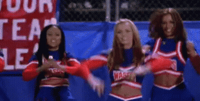 A Group Of Cheerleaders Are Standing Next To Each Other In Front Of A Sign That Says Warriors . GIF