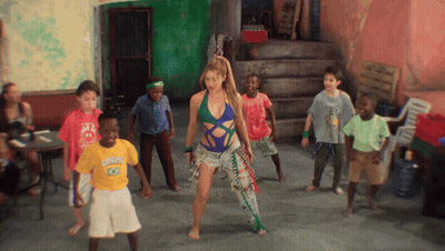 A Group Of Children Are Dancing In A Room And One Of Them Is Wearing A Shirt That Says Rio De Janeiro GIF