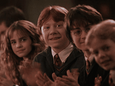 A Group Of Children Are Sitting In A Row Clapping GIF