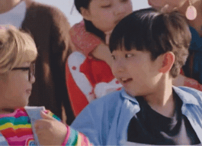 A Group Of Children Are Sitting In A Stadium Watching A Game . GIF