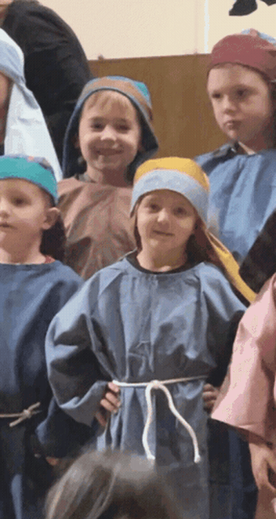 A Group Of Children Dressed In Blue Robes And Blue Hats GIF