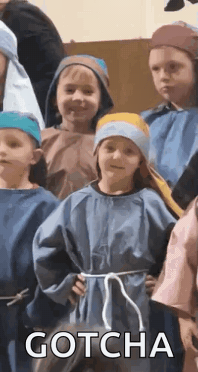 A Group Of Children Dressed In Costumes Are Standing Next To Each Other And One Of Them Is Wearing A Blue Robe . GIF