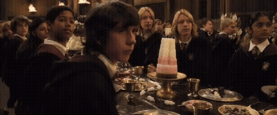 A Group Of Children Sit At A Table With A Cake On It GIF