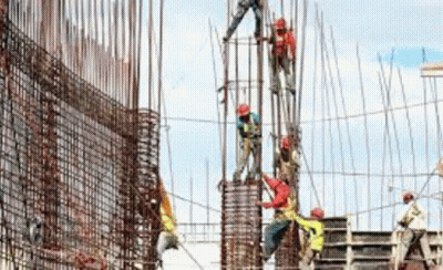 A Group Of Construction Workers Are Working On A Large Building . GIF