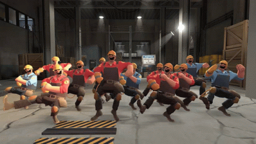 A Group Of Construction Workers Dancing In A Warehouse GIF