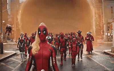 A Group Of Deadpools Walking Down A Street GIF
