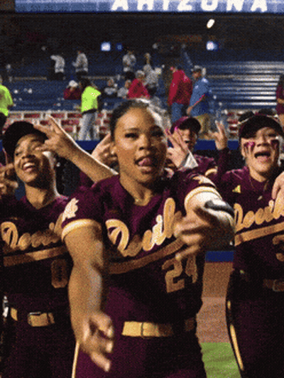 A Group Of Devils Baseball Players Are Dancing In Front Of A Crowd GIF