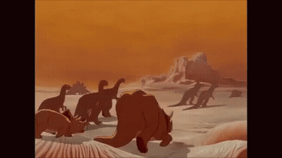 A Group Of Dinosaurs Are Walking Across A Desert Landscape . GIF