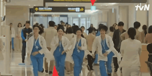 A Group Of Doctors Are Running Through A Hospital Hallway With Tvn Written On The Bottom GIF