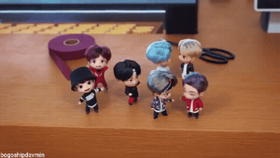 A Group Of Dolls Are Standing On A Wooden Table With The Hashtag Bogoshipdarmin GIF
