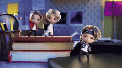 A Group Of Dolls Are Standing On Top Of A Pile Of Books . GIF