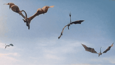 A Group Of Dragons Are Flying Over A City With Mountains In The Background GIF