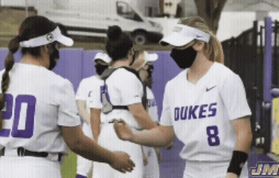 A Group Of Dukes Softball Players Wearing Face Masks GIF