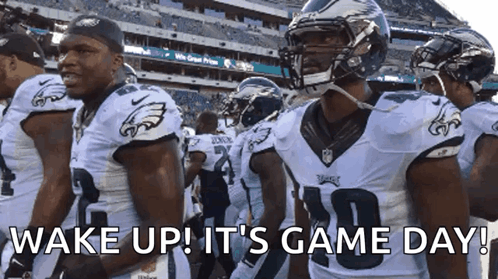 A Group Of Eagles Football Players Are Standing In A Stadium With The Words Wake Up It 'S Game Day GIF