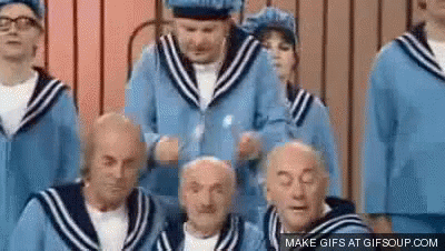 A Group Of Elderly Men In Sailor Suits Are Standing In A Line . GIF
