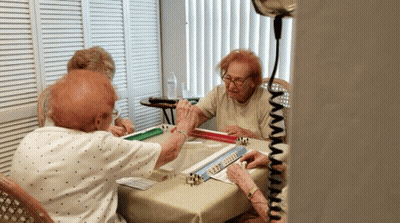 A Group Of Elderly People Are Playing Mahjong GIF