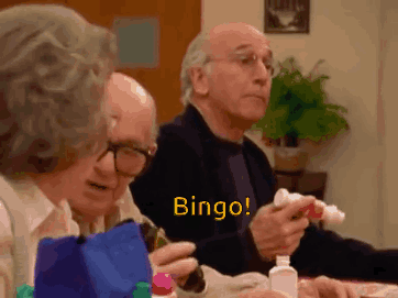 A Group Of Elderly People Are Sitting At A Table And Playing Bingo . GIF