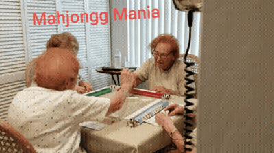 A Group Of Elderly Women Are Playing Mahjongg With The Words Mahjongg Mania Written Above Them GIF