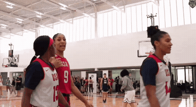 A Group Of Female Basketball Players Are Standing On A Court And One Has The Number 9 On Her Jersey GIF